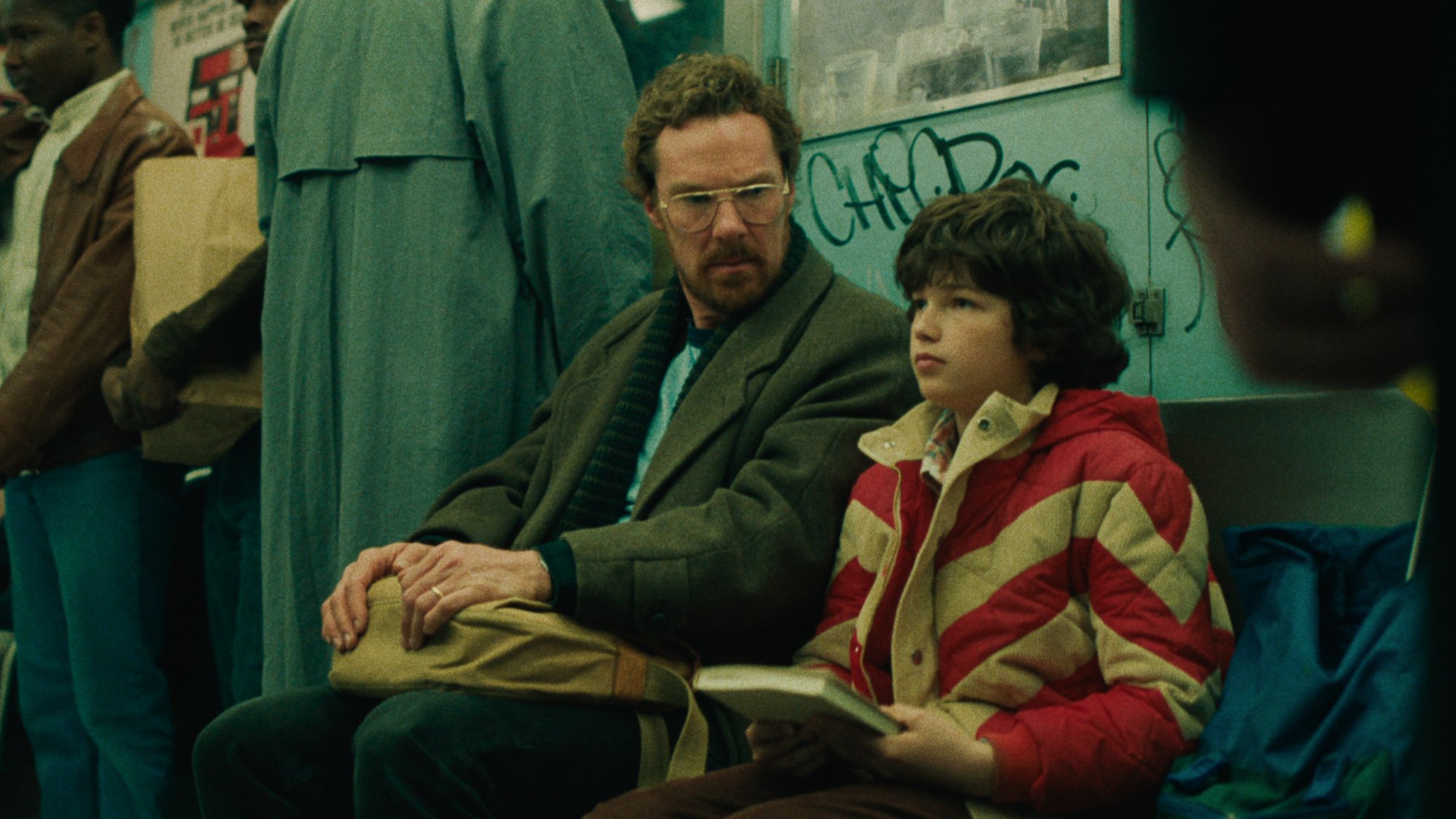 A father and son sit next to each other on public transportation; Benedict Cumberbatch as Vincent / Ivan Howe as Edgar