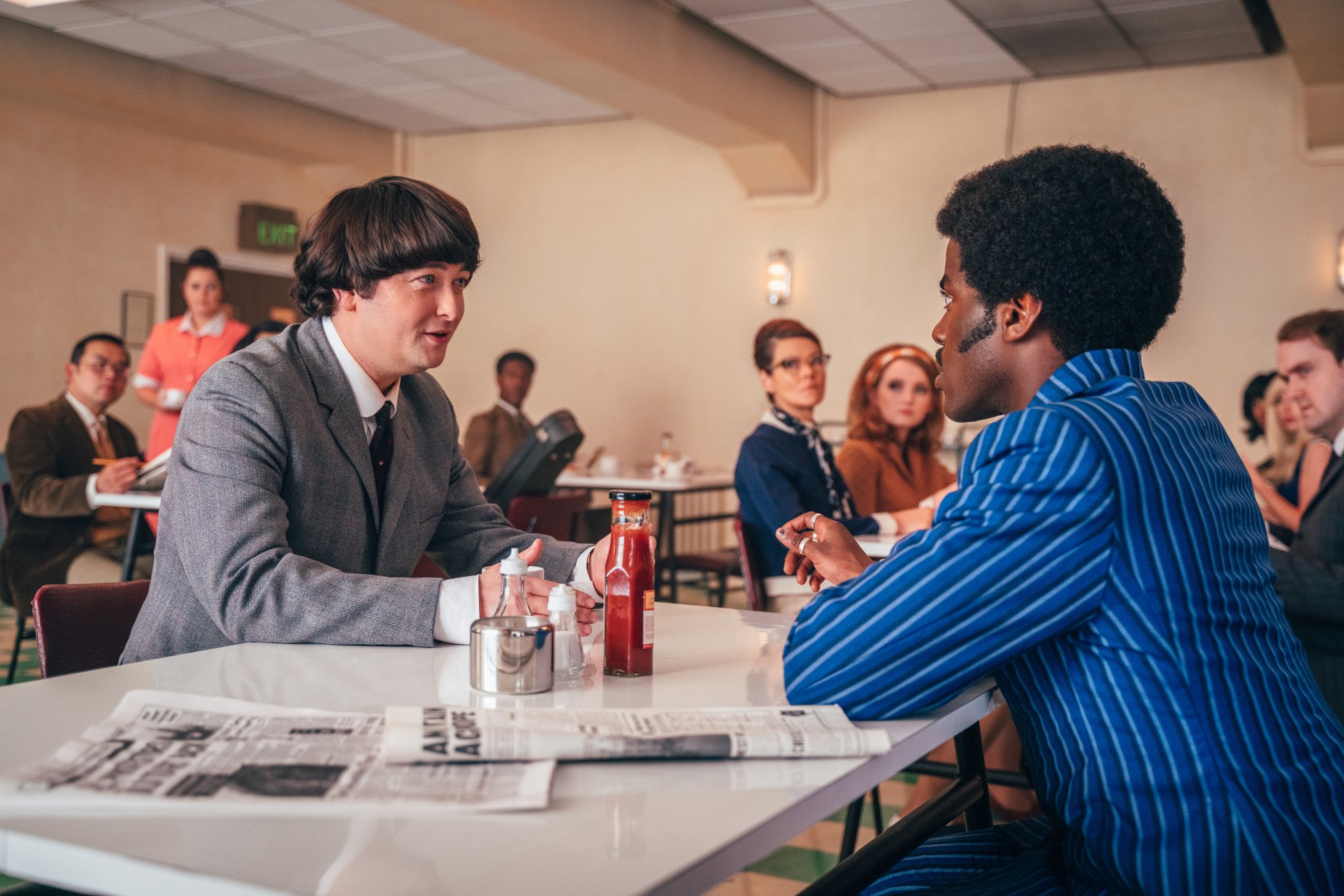 Paul McCartney and the Doctor at a dinner table.