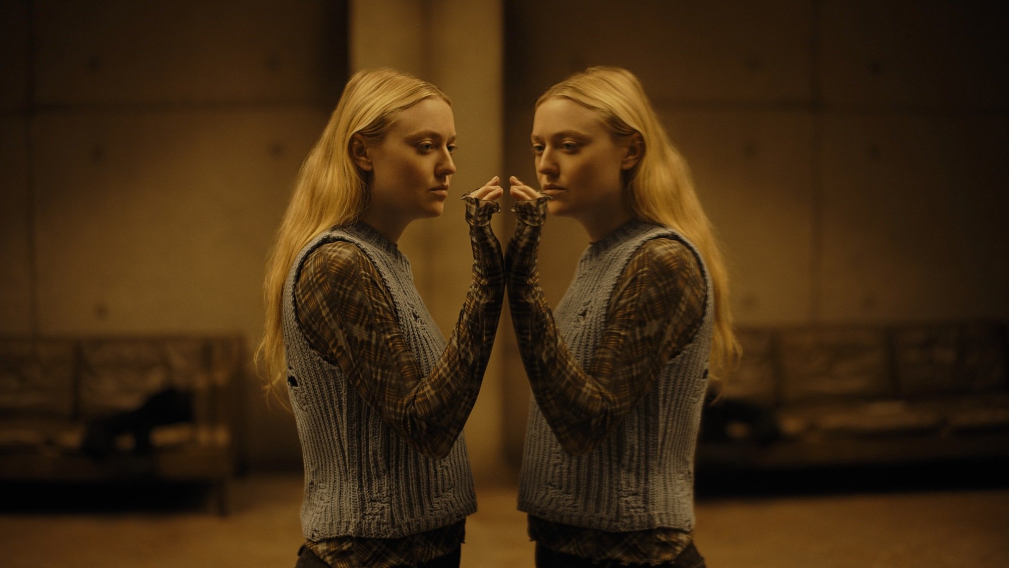 Dakota Fanning looks into a mirror in "The Watchers."