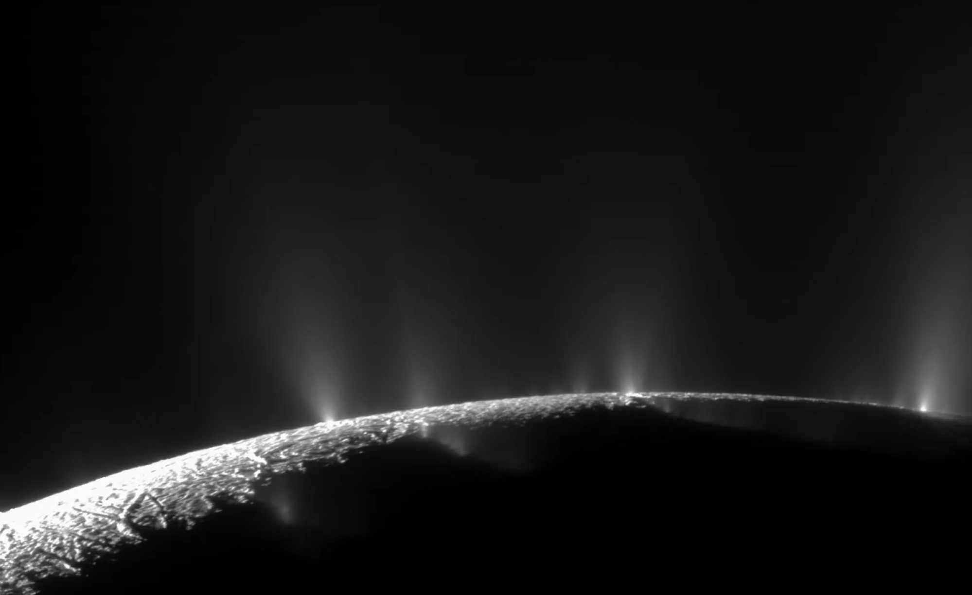 Plumes of water ice shooting out of Saturn's moon Enceladus. The briny ocean below could potentially host life.