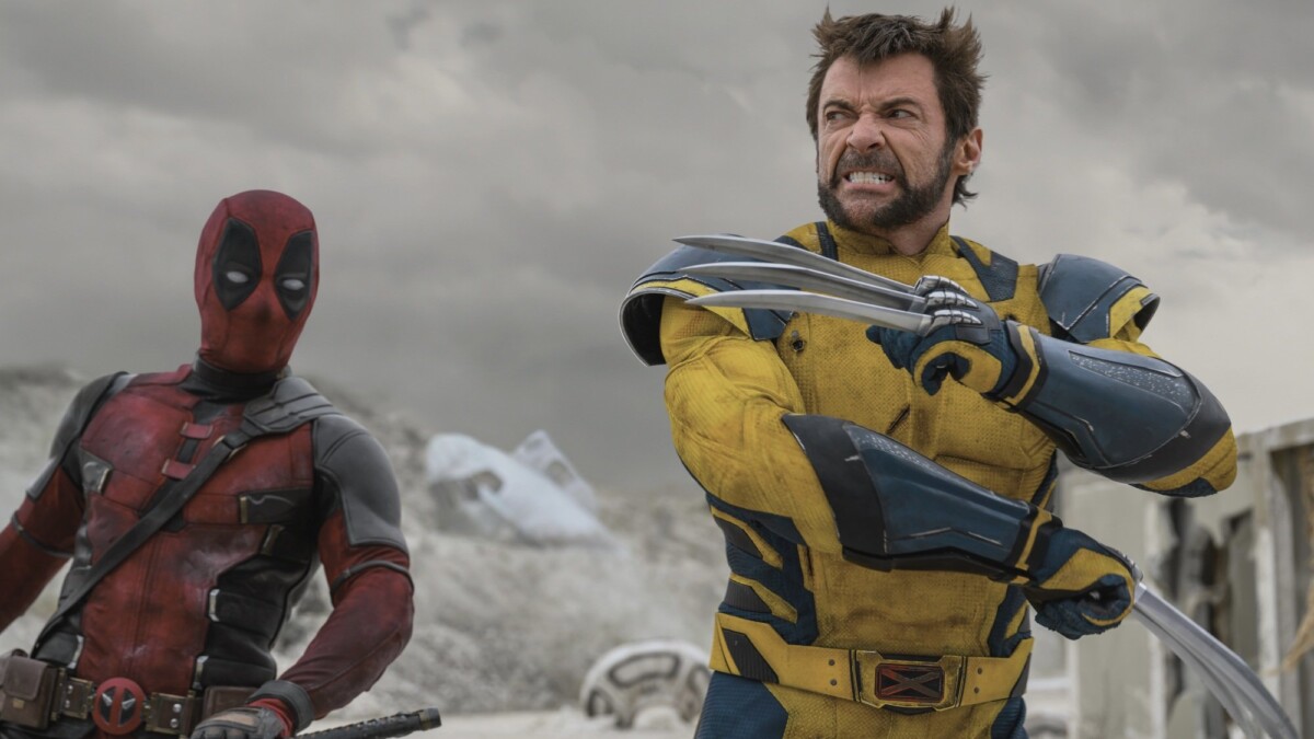 Deadpool and Wolverine prepare to do battle in a grey wasteland.