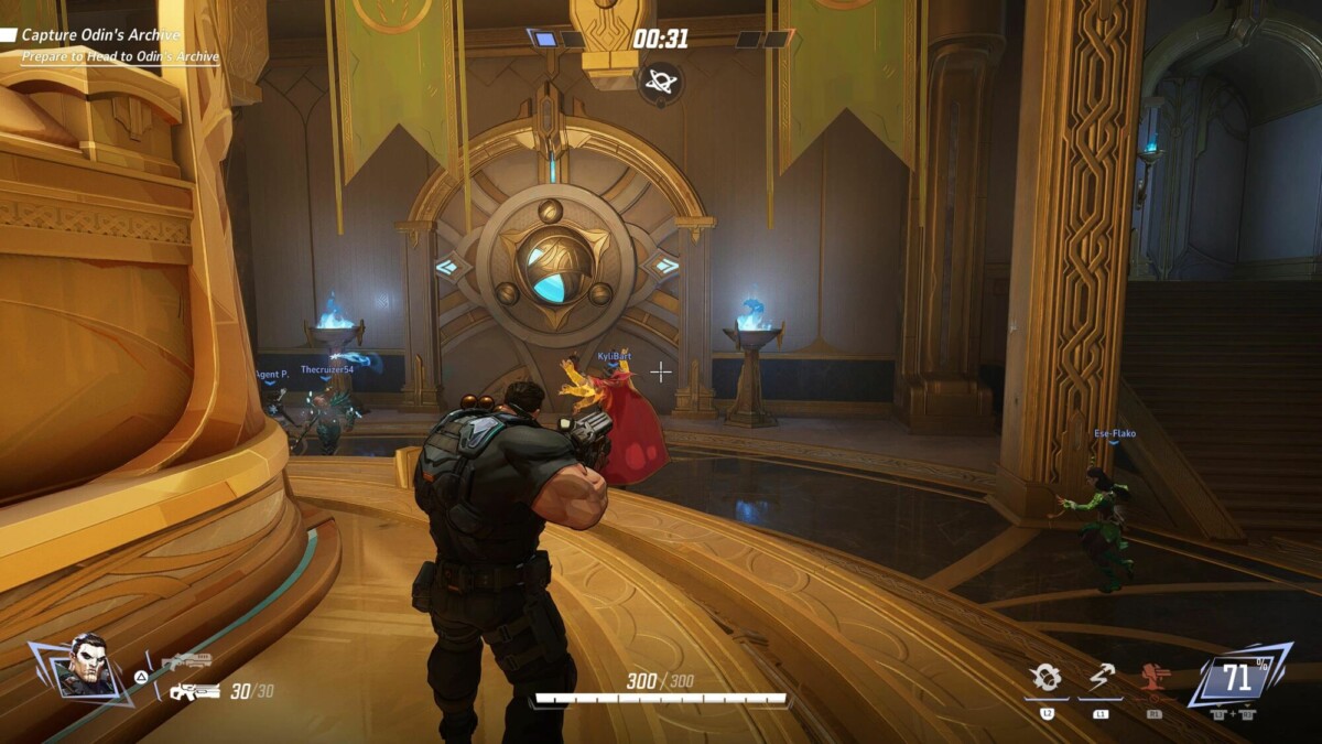 A player in a tactical game, aiming at a large ornate door with teammates nearby, preparing to capture "Odin's Archive."