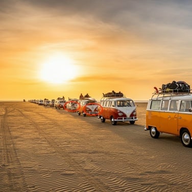 imagen 3 generated image of a parade of Volkswagen busses driving on a beach at sunset