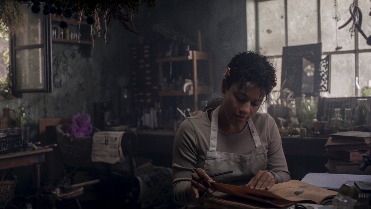 Chef peers through notebooks in an old kitchen.