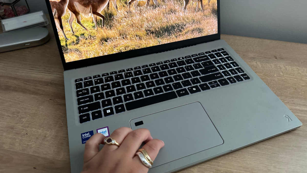 A person's hand using the touchpad on the Acer Aspire Vero 16.