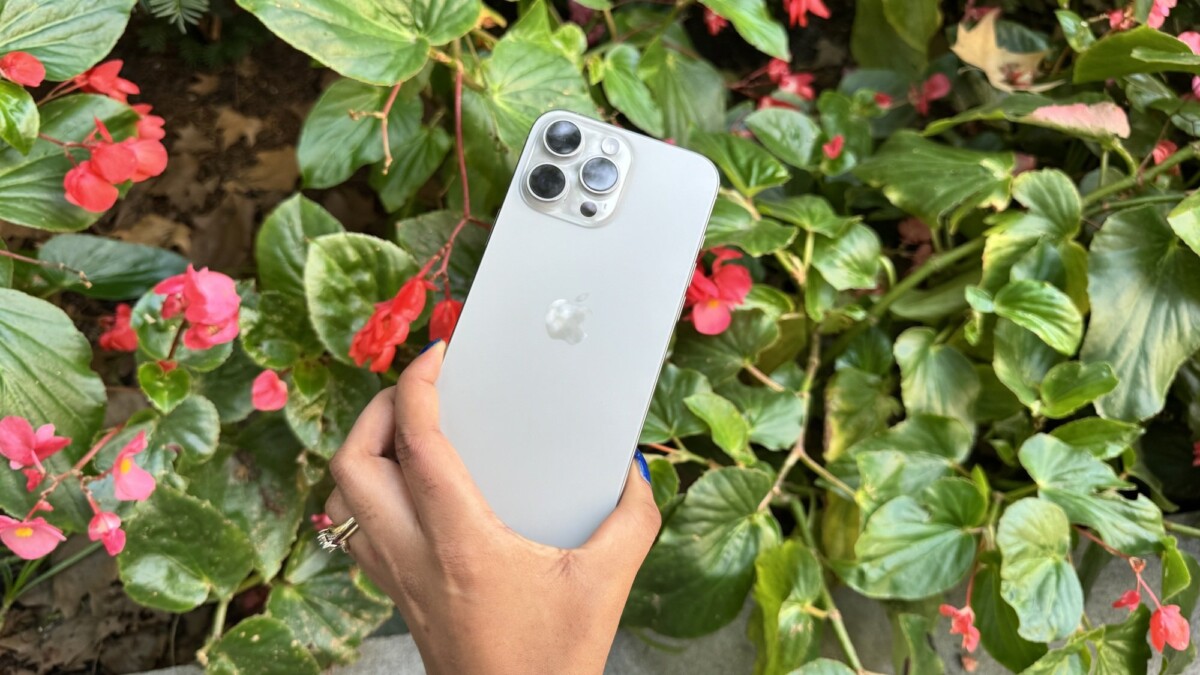 iPhone 16 Pro Max in front of a floral arrangement