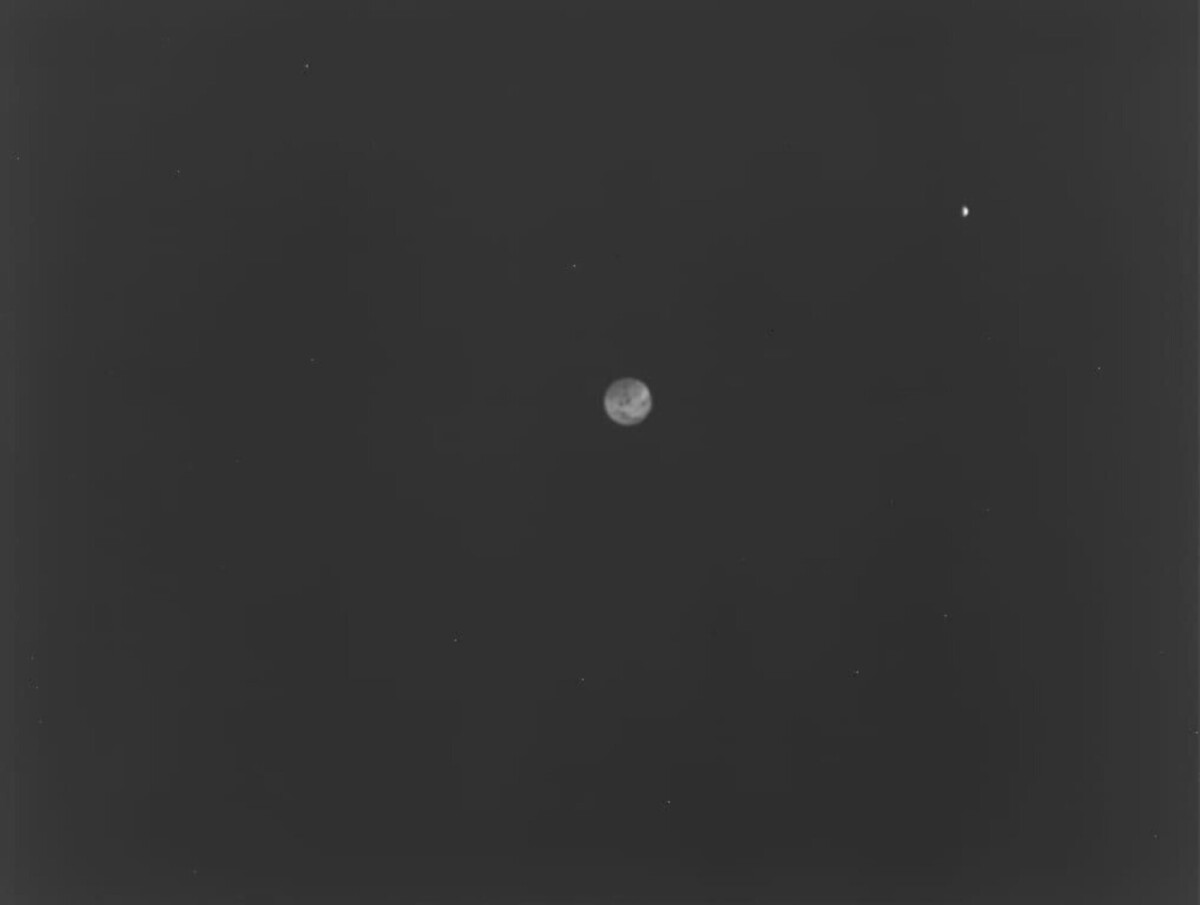 Earth (center) and the moon (upper right) as viewed by Hera's Thermal Infrared Imager.