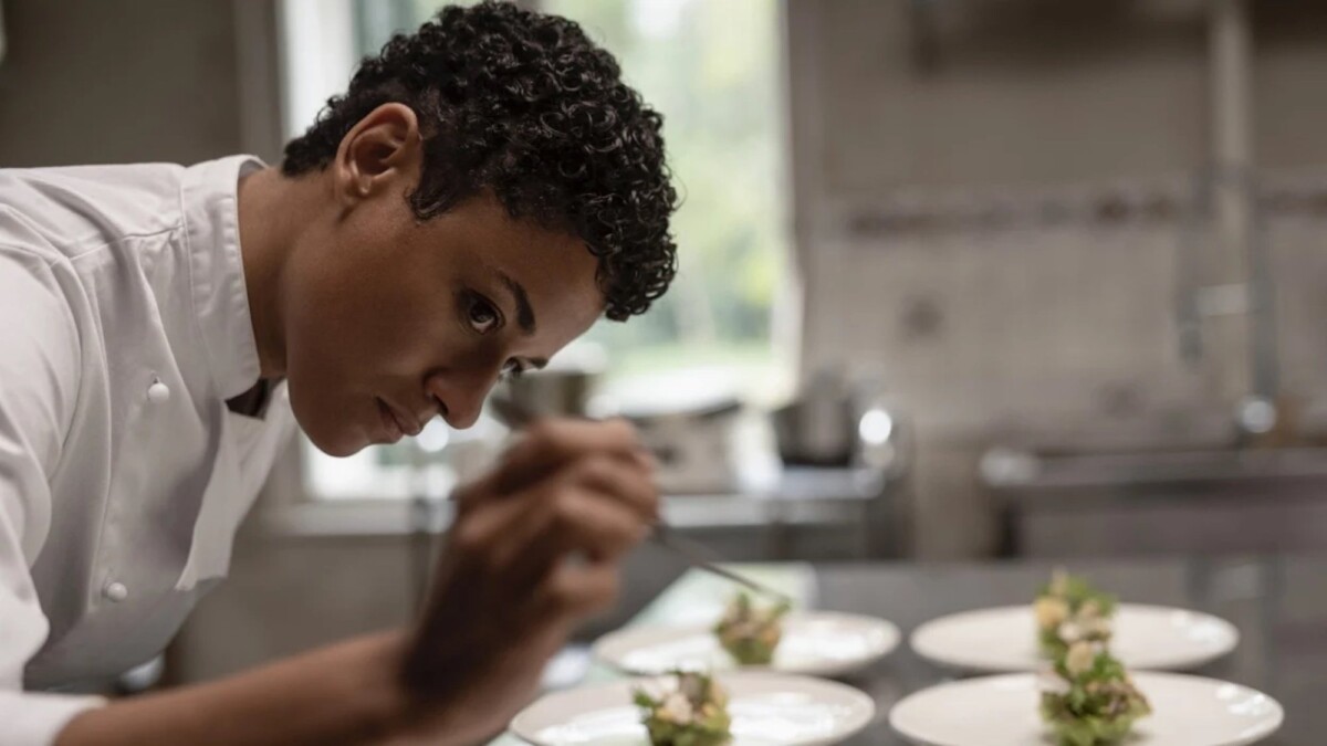 Ariana DeBose in "House of Spoils" playing a chef tending to a plate.