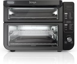 Ninja air fryer oven with two layers of trays seen through glass door