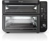 Ninja air fryer oven with two layers of trays seen through glass door