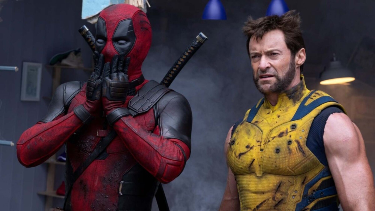 Ryan Reynolds as Deadpool and Hugh Jackman as Wolverine standing side by side