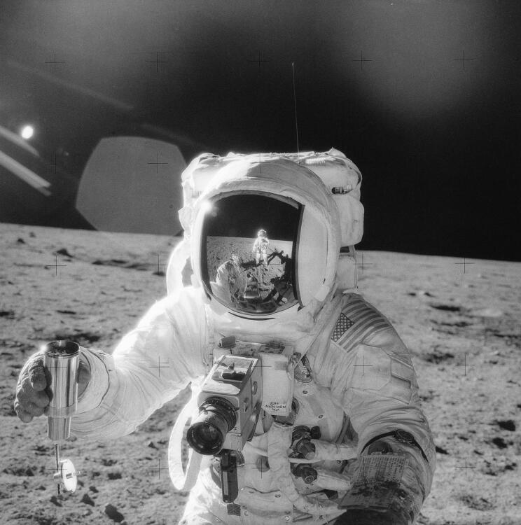 Apollo 12 astronaut collecting lunar soil