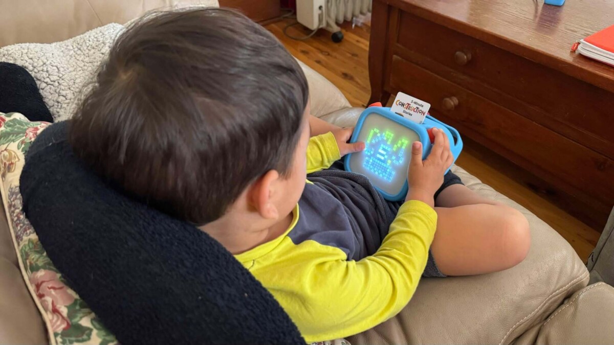 A toddler using the Yoto Player.