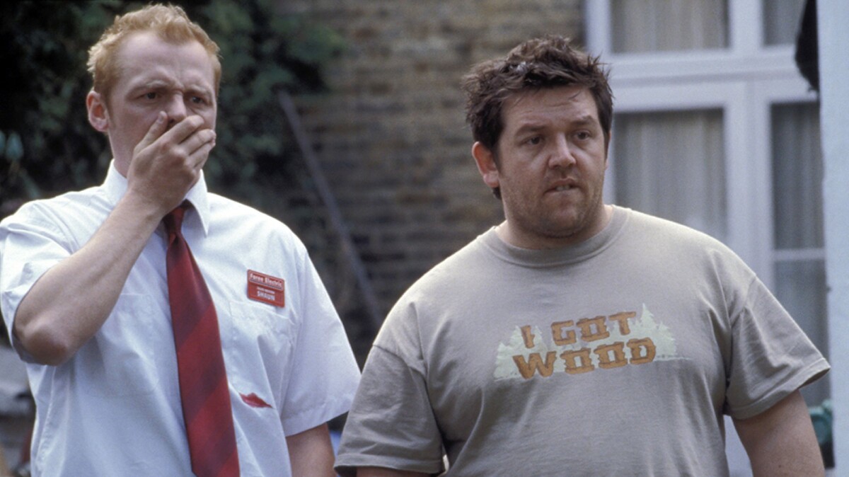 Two men stand outside, looking shocked.