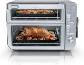 the ninja countertop stack XL oven with a tray of salmon baking on in the upper oven and a roast chicken on the bottom