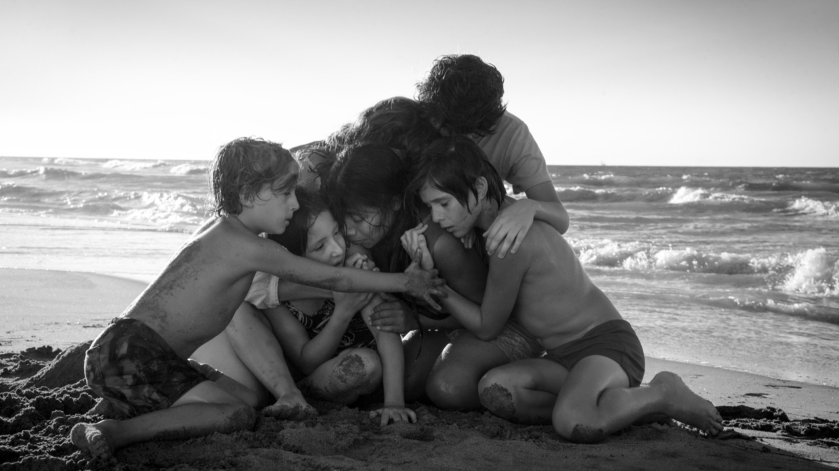 A family hug on the beach. 