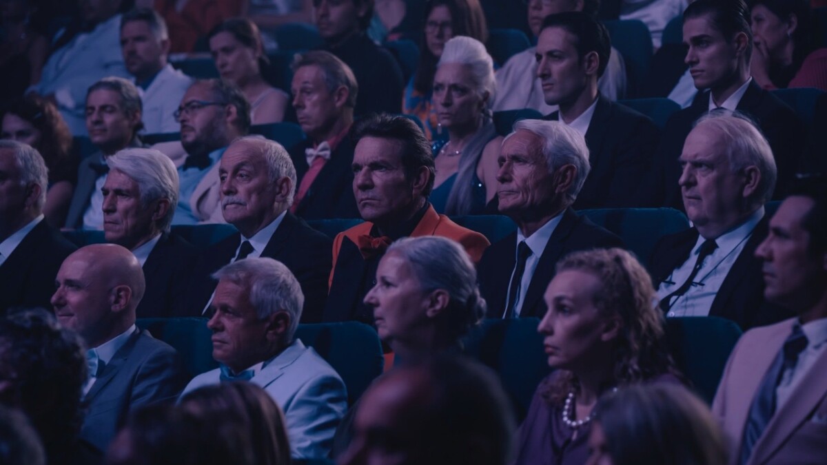 Old men and women sit in a theater in 'The Substance."