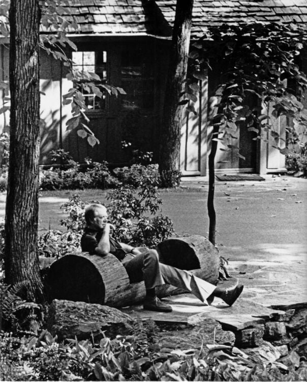 President Jimmy Carter sitting alone on a bench at Camp David